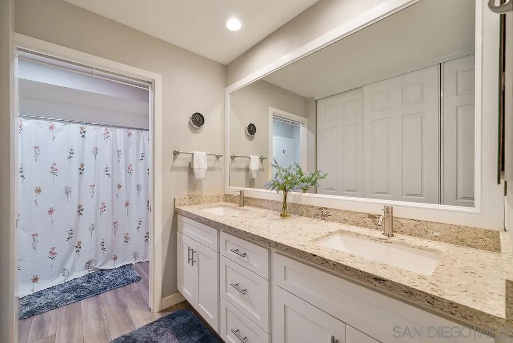 17637 Pomerado Road, Unit 123 San Diego, CA 92128 - Photo 14 of 52 a bathroom with a granite countertop sink and a mirror