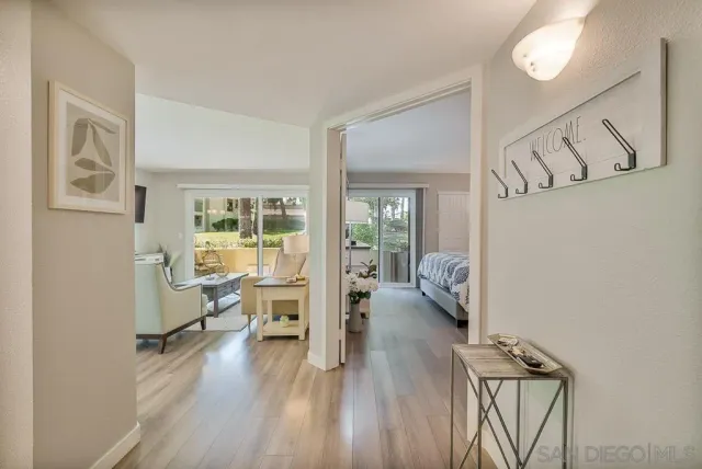 a view of a dining room with furniture a chandelier and wooden floor