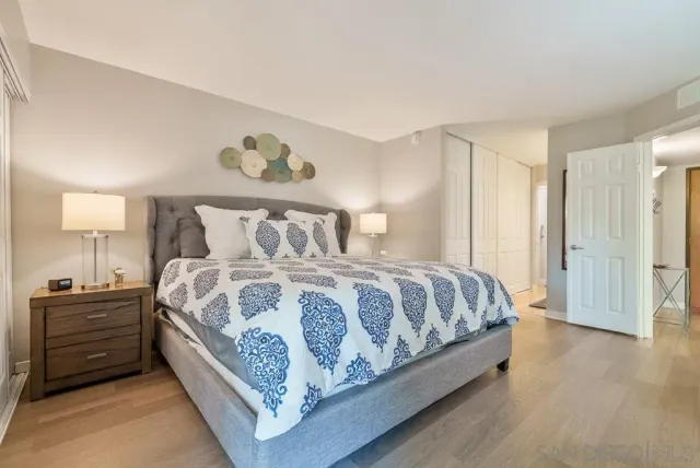 a living room with furniture a flat screen tv and kitchen view