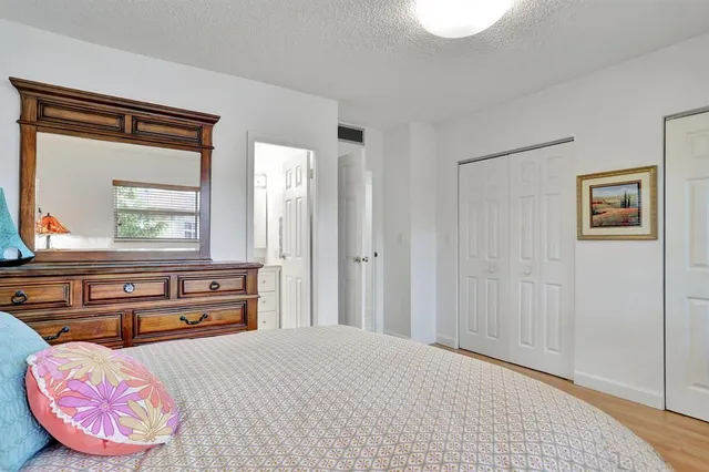 a kitchen with stainless steel appliances white cabinets and a refrigerator