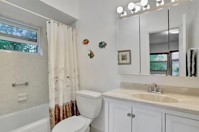 a white refrigerator freezer and a stove sitting inside of a kitchen