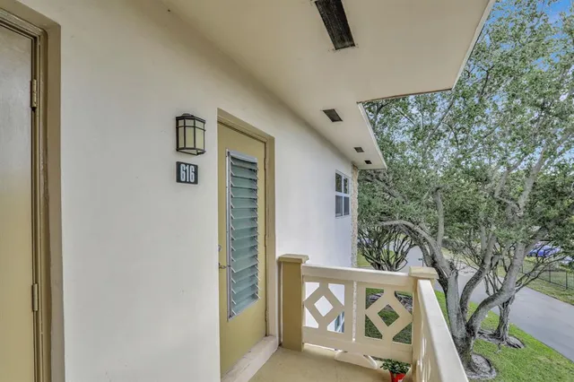 a yard with yellow house