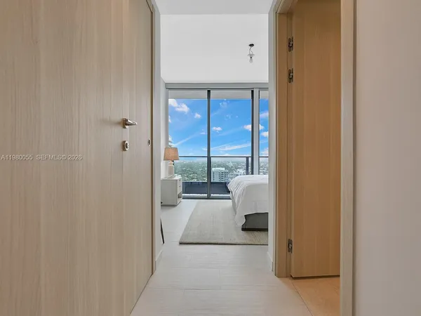 a large bedroom with a large window and a balcony