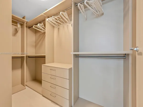 a view of a hallway with wooden shelves