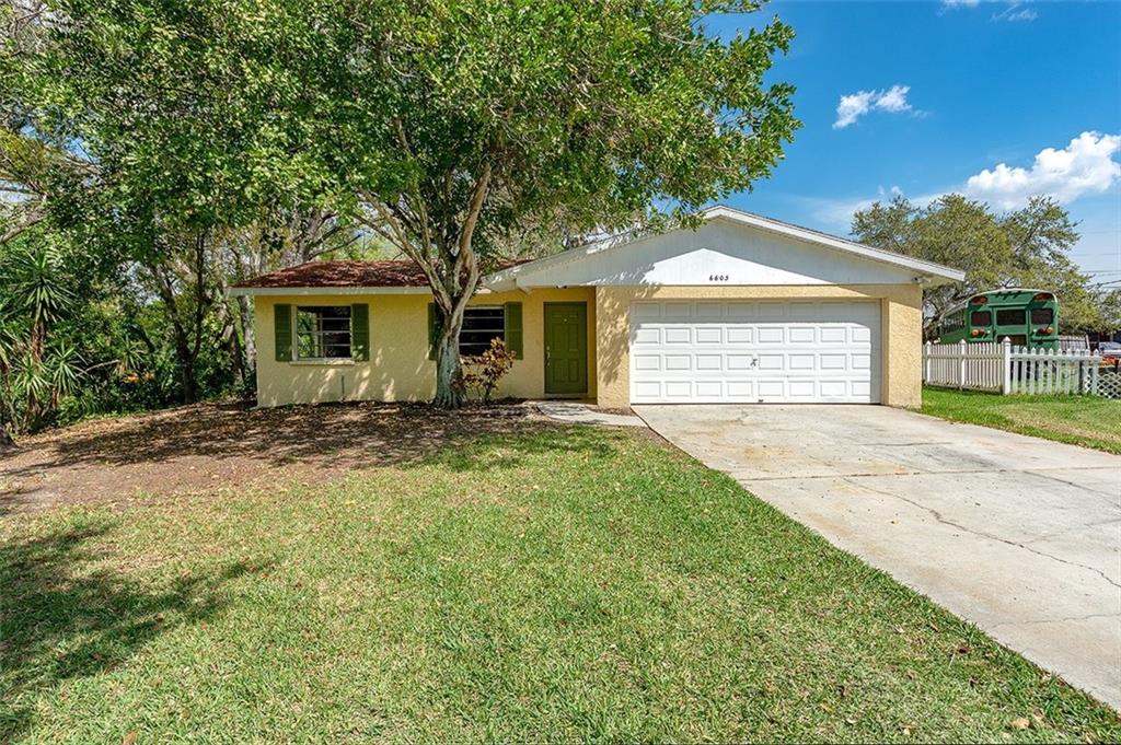 6603 Sabina Road Sarasota, FL 34243 - Photo 1 of 1 a front view of house with yard and trees