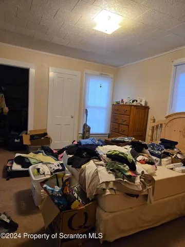 a bedroom with furniture and a rug