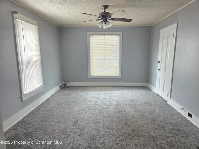a view of room with a ceiling fan