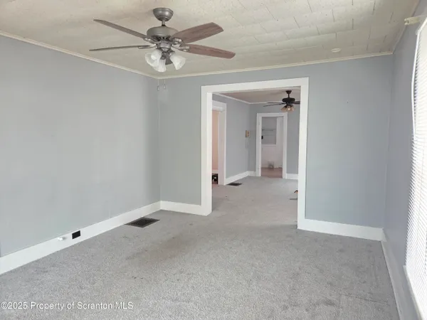 an empty room with windows and closet