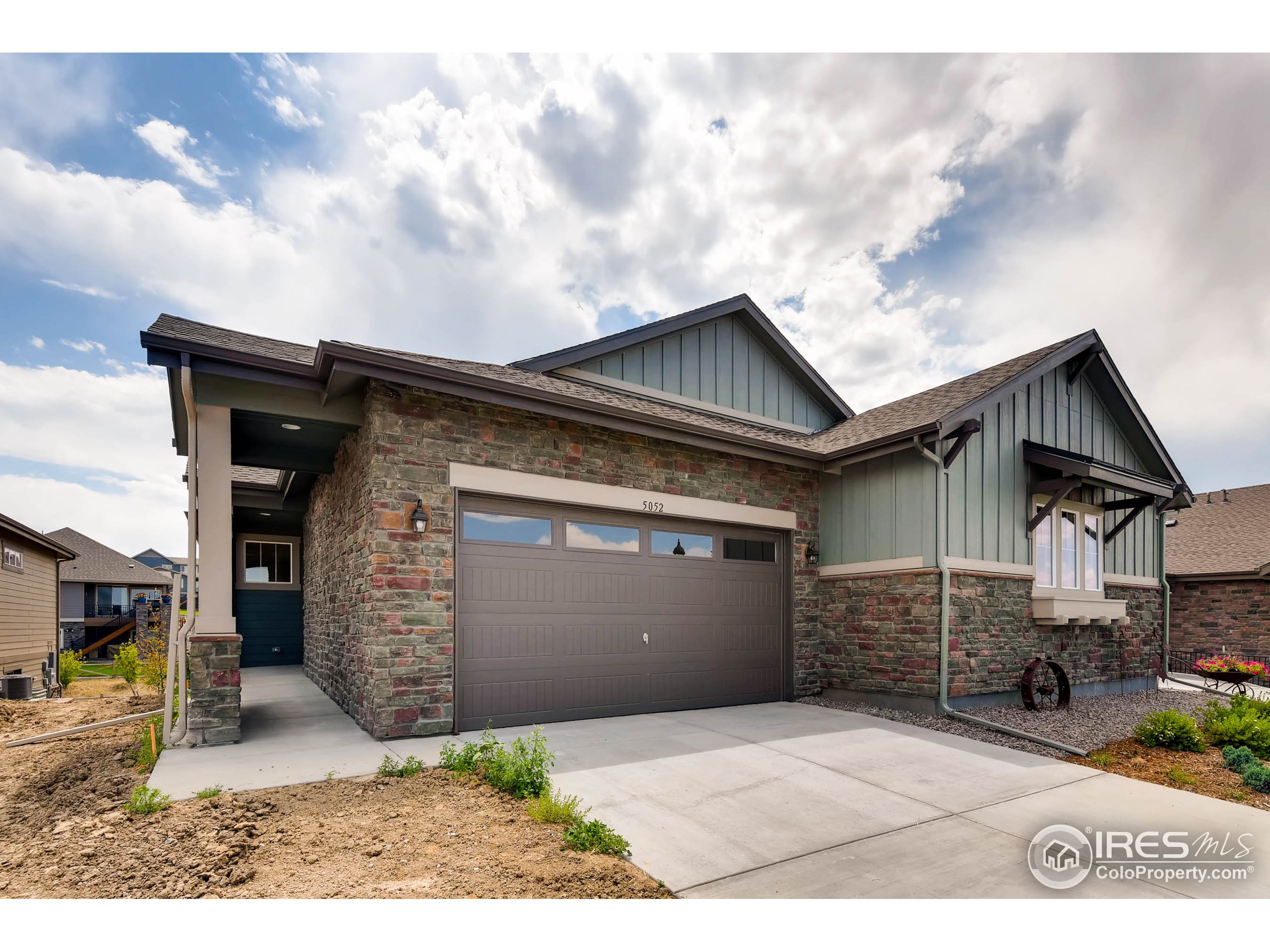 a backyard of a house with dishwasher and garage