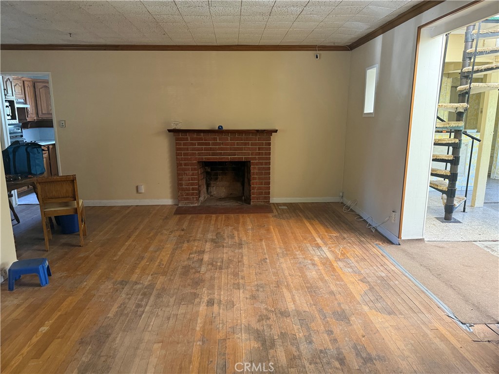 19131 Lanark Street Reseda, CA 91335 - Photo 2 of 14 a view of empty room with wooden floor and fireplace