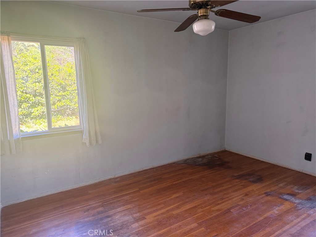19131 Lanark Street Reseda, CA 91335 - Photo 5 of 14 a view of a room with wooden floor and fan
