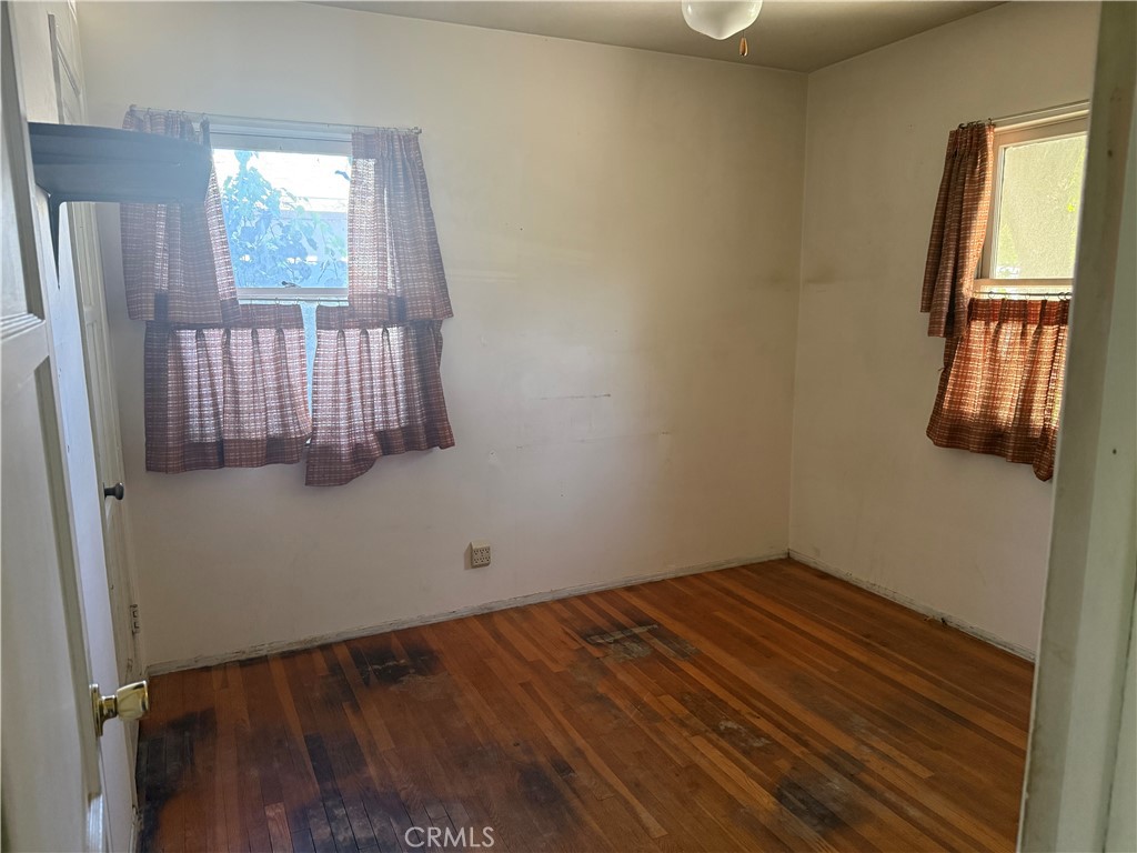 19131 Lanark Street Reseda, CA 91335 - Photo 6 of 14 a view of empty room with wooden floor and fan