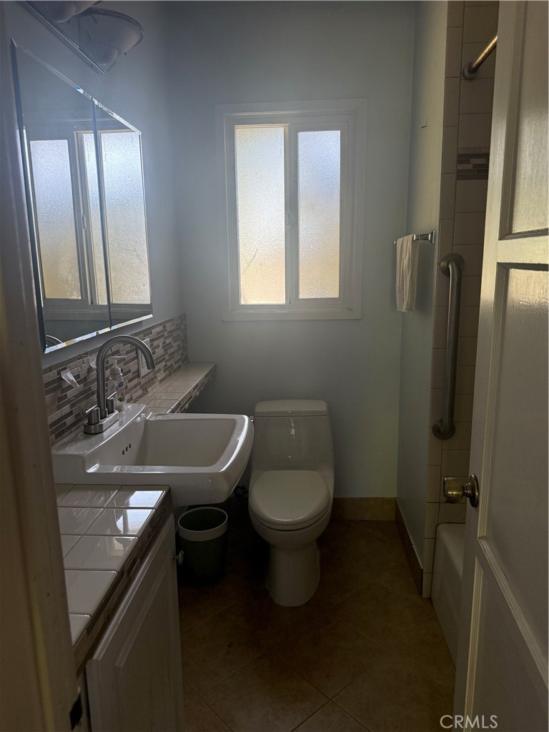 19131 Lanark Street Reseda, CA 91335 - Photo 7 of 14 a bathroom with a sink toilet and mirror