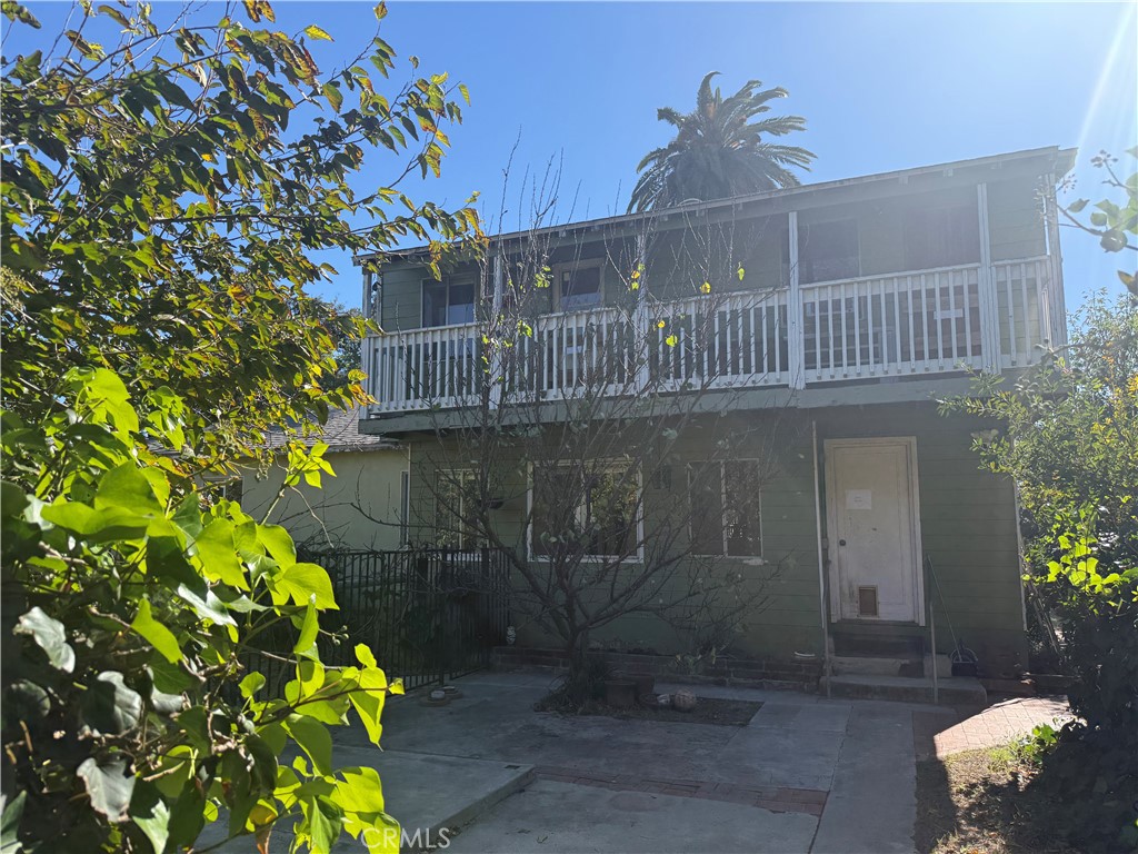 19131 Lanark Street Reseda, CA 91335 - Photo 8 of 14 a front view of a house with a yard