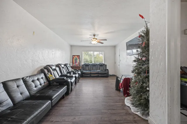 a living room with furniture window and wooden floor