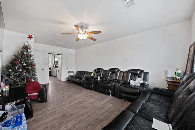 a living room with furniture or wooden floor and a potted plant