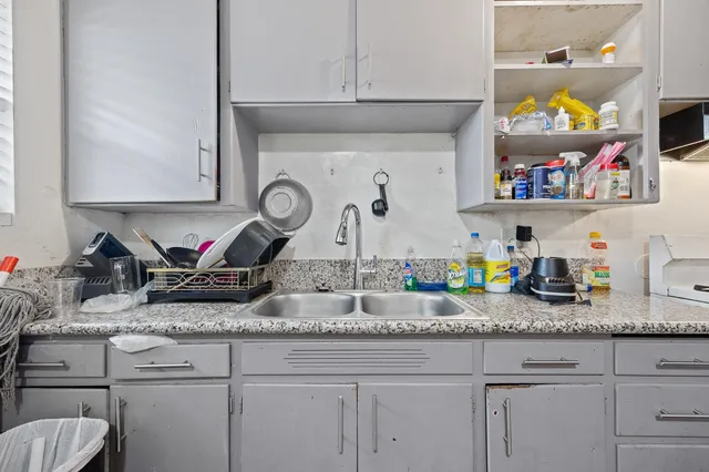 a kitchen with sink cabinets and window