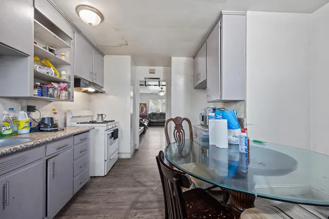 a kitchen with stainless steel appliances granite countertop a sink dishwasher and cabinets with wooden floor