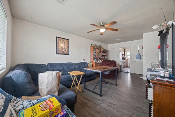 a living room with furniture and a wooden floor