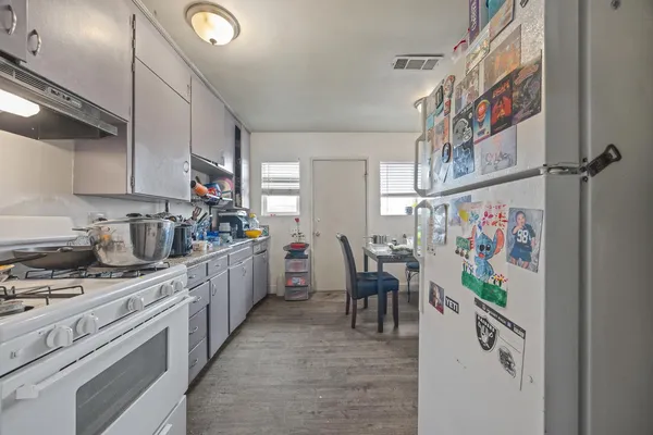 a kitchen with stainless steel appliances granite countertop a sink and cabinets