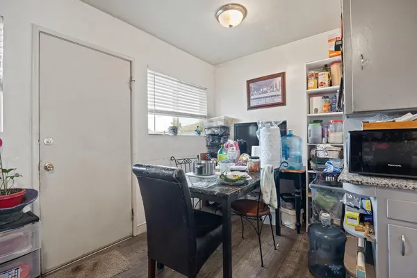 a dining room with furniture and wooden floor