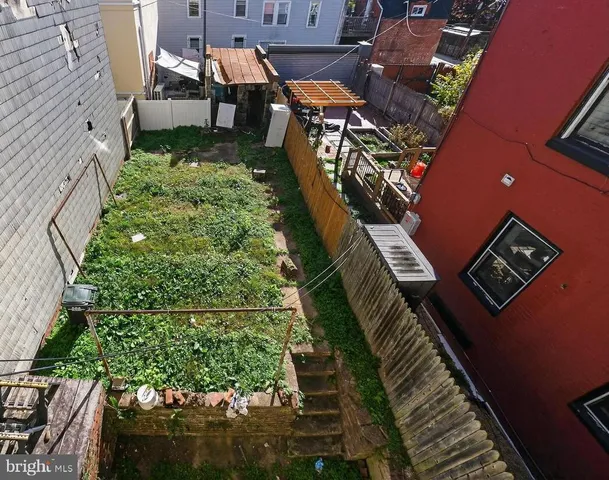 a view of a backyard with sitting area