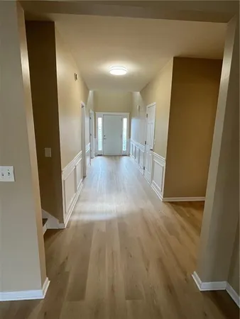 a view of a hallway with wooden floor