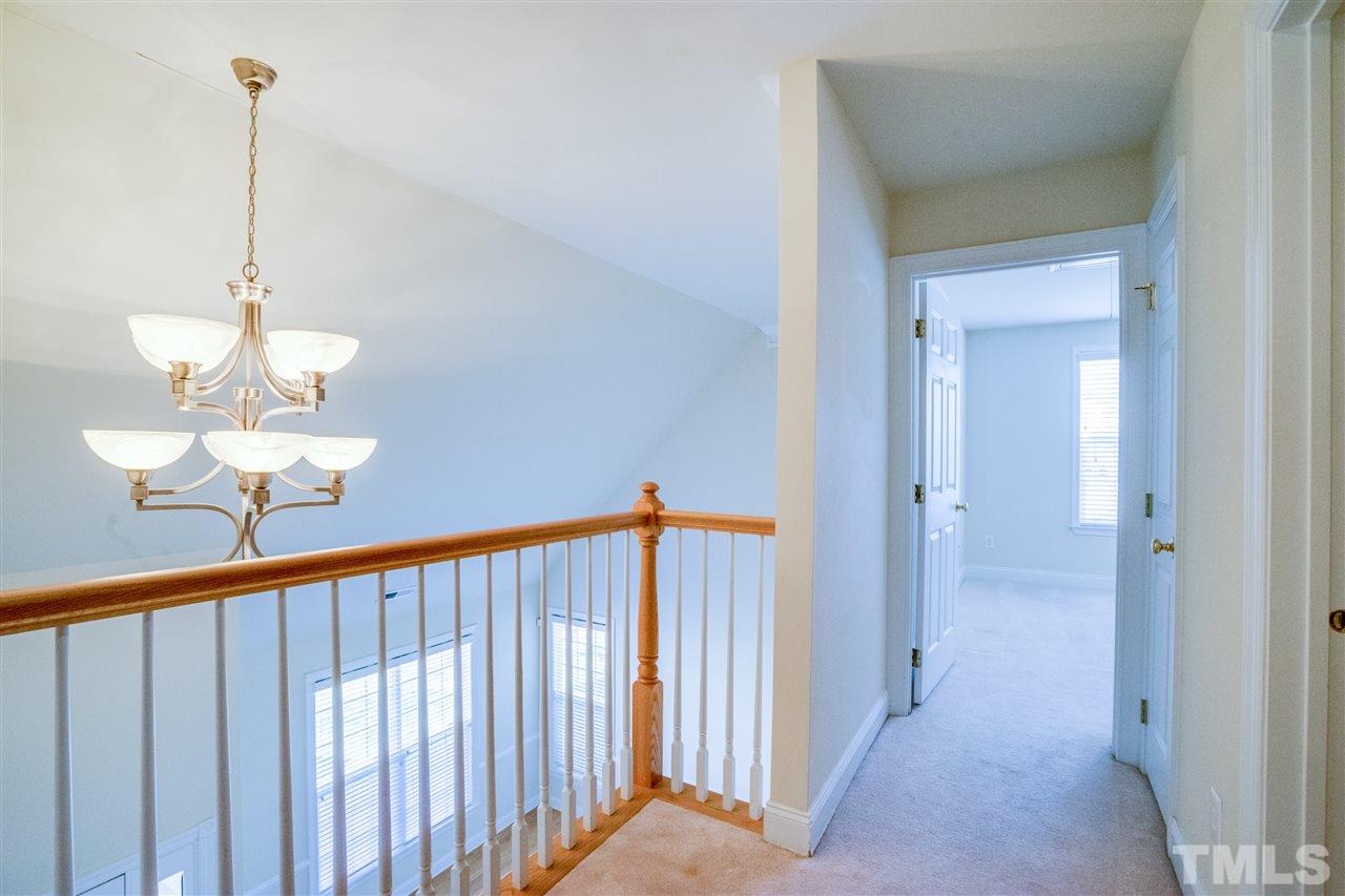 11115 Maplecroft Court Raleigh, NC 27617 - Photo 18 of 25 a view of a hallway with a chandelier