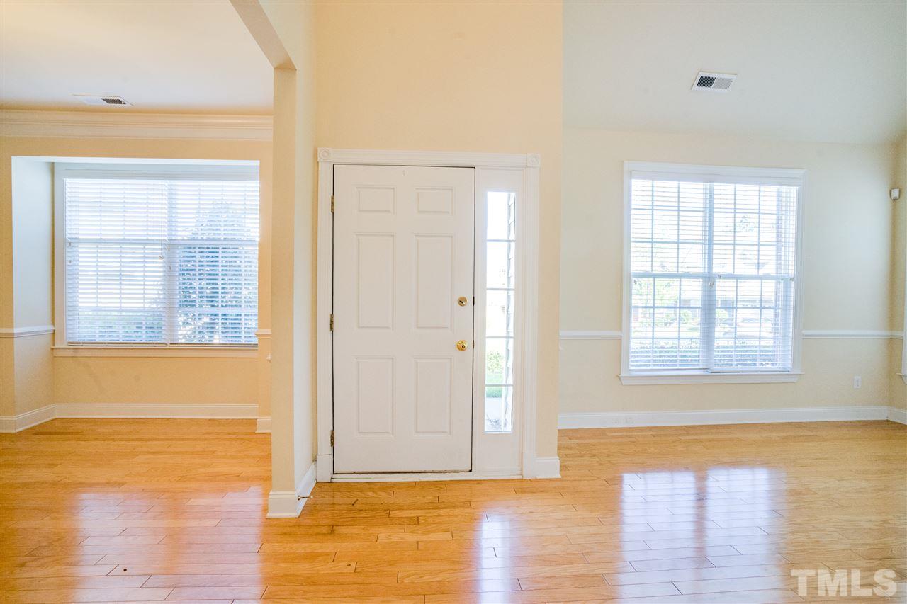 11115 Maplecroft Court Raleigh, NC 27617 - Photo 3 of 25 a view of an empty room with wooden floor and a window
