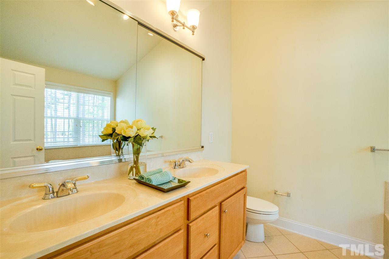 11115 Maplecroft Court Raleigh, NC 27617 - Photo 21 of 25 a bathroom with a sink a toilet and tub