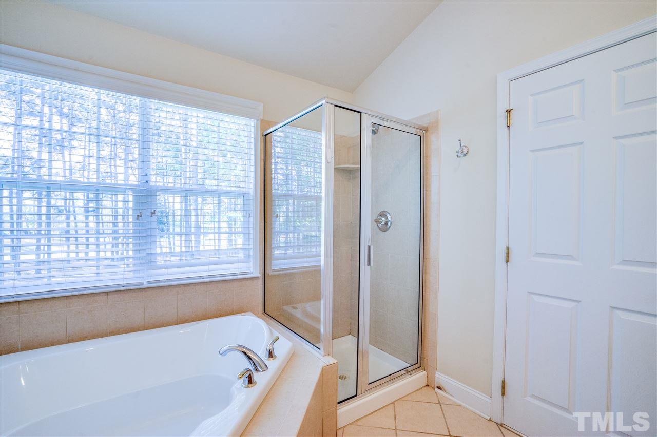 11115 Maplecroft Court Raleigh, NC 27617 - Photo 22 of 25 a bathroom with a bathtub and a shower