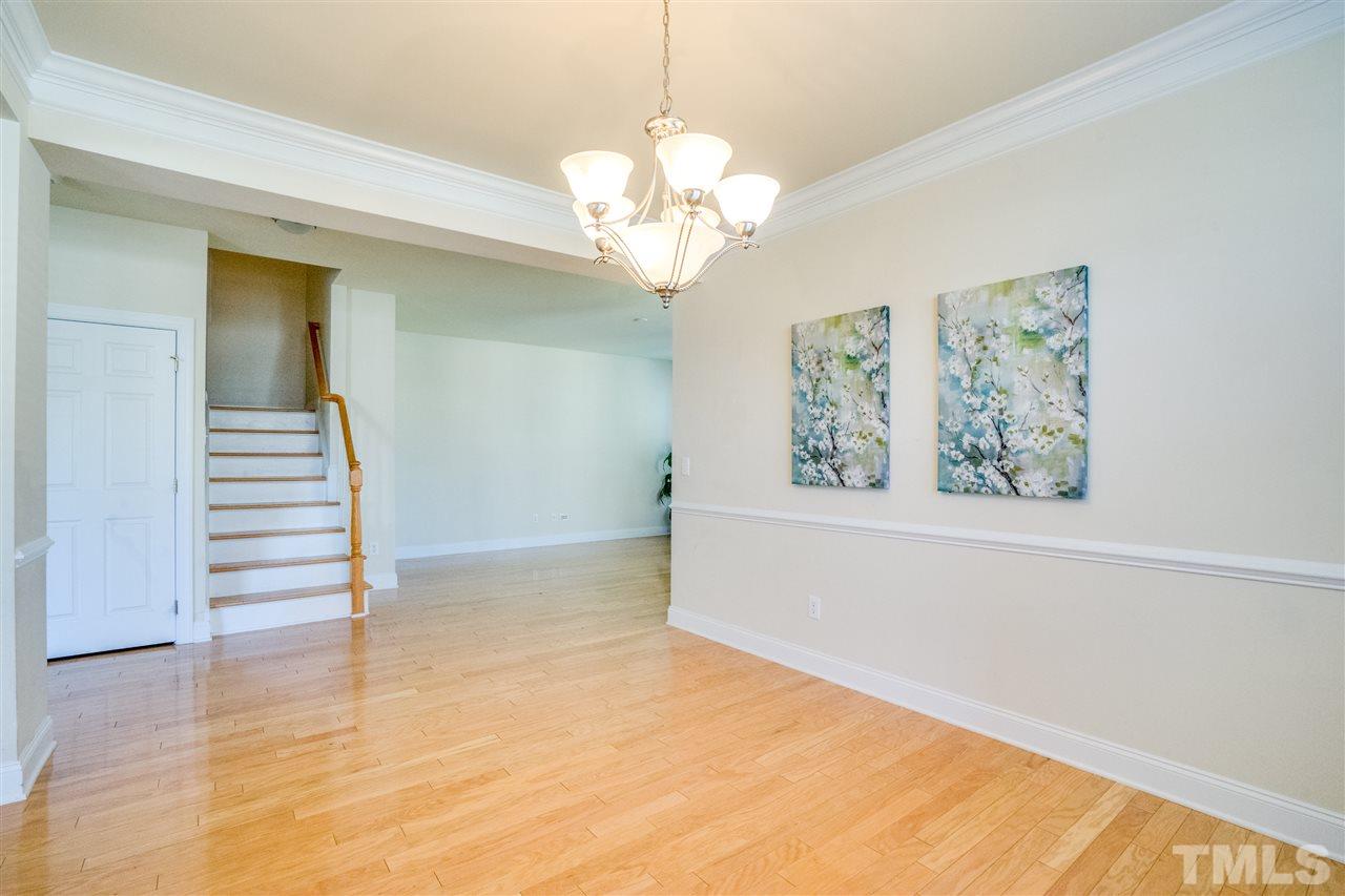 11115 Maplecroft Court Raleigh, NC 27617 - Photo 8 of 25 a view of an empty room with wooden floor and a window