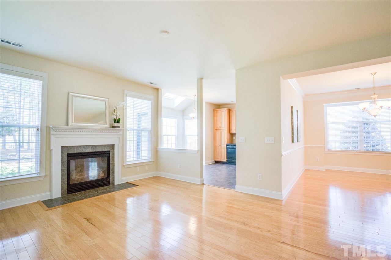 11115 Maplecroft Court Raleigh, NC 27617 - Photo 9 of 25 a view of an empty room with glass door and wooden floor