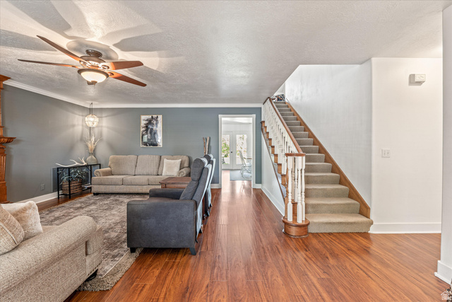 246 West Mount Charm Road Toquerville, UT 84774 - Photo 10 of 70 Living area featuring a textured ceiling, wood finished floors, a ceiling fan, and crown molding