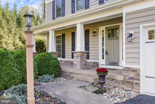 a front view of a house with outdoor seating