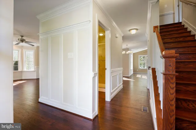 a view of entryway and hall with wooden floor