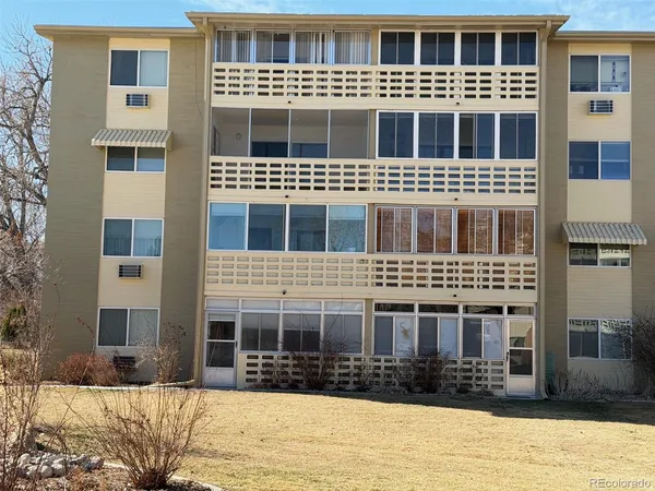 a front view of a building with a yard