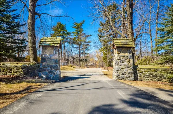 a view of entrance gate of the house and trees