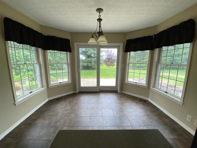 11426 East Radisson Road Mount Vernon, IL 62864 - Photo 6 of 56 a view of an empty room with wooden floor and a window