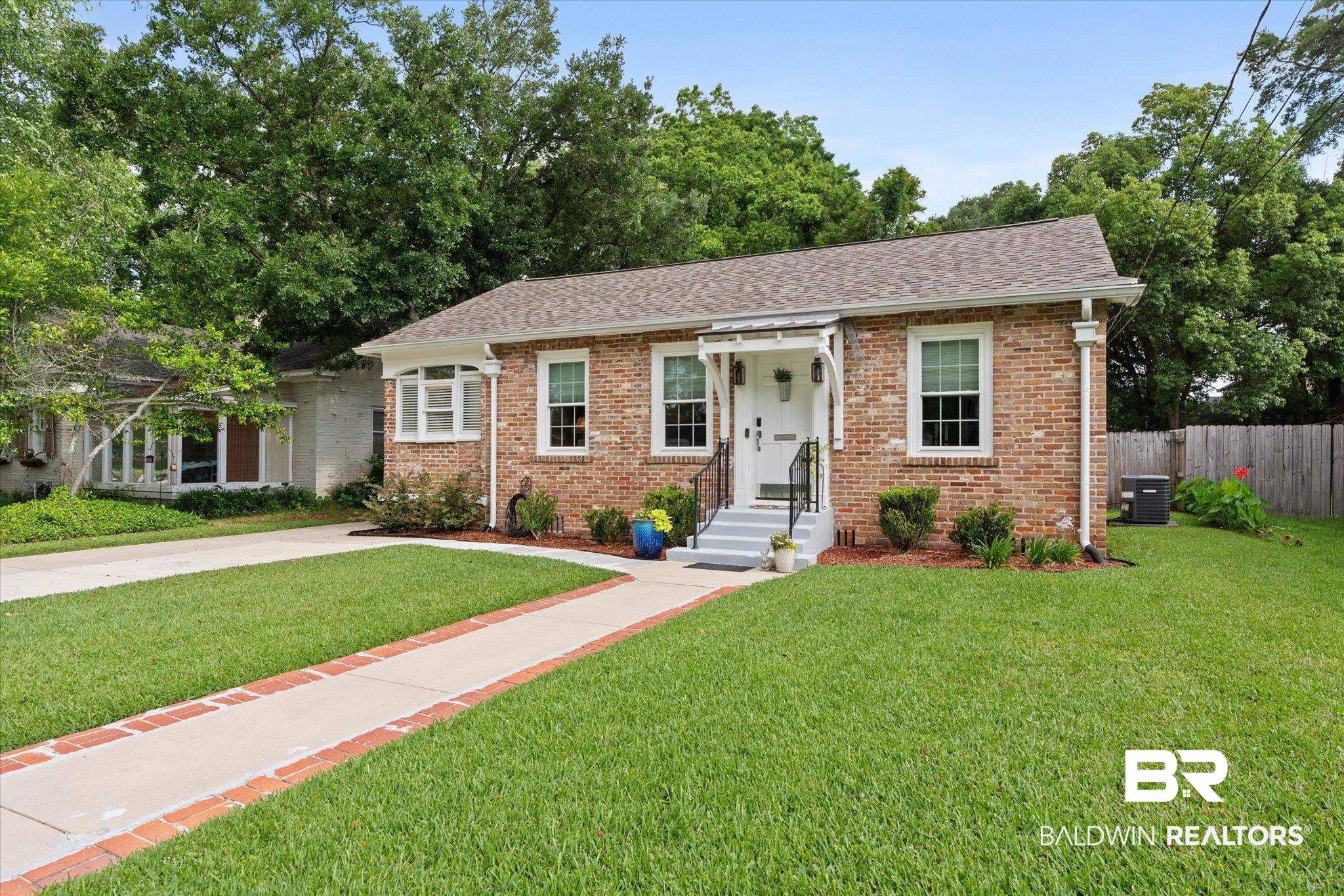 1910 Hunter Avenue Mobile, AL 36606 - Photo 1 of 21 View of front of property featuring brick siding, a shingled roof, and cooling unit