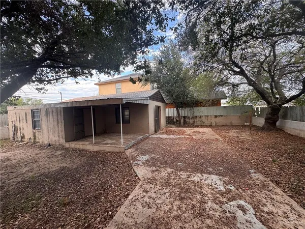 a view of a house with a yard and garage