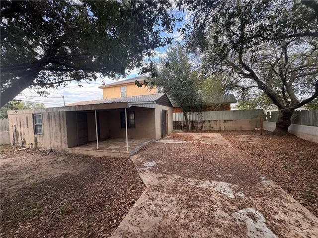 a view of a house with a yard and garage