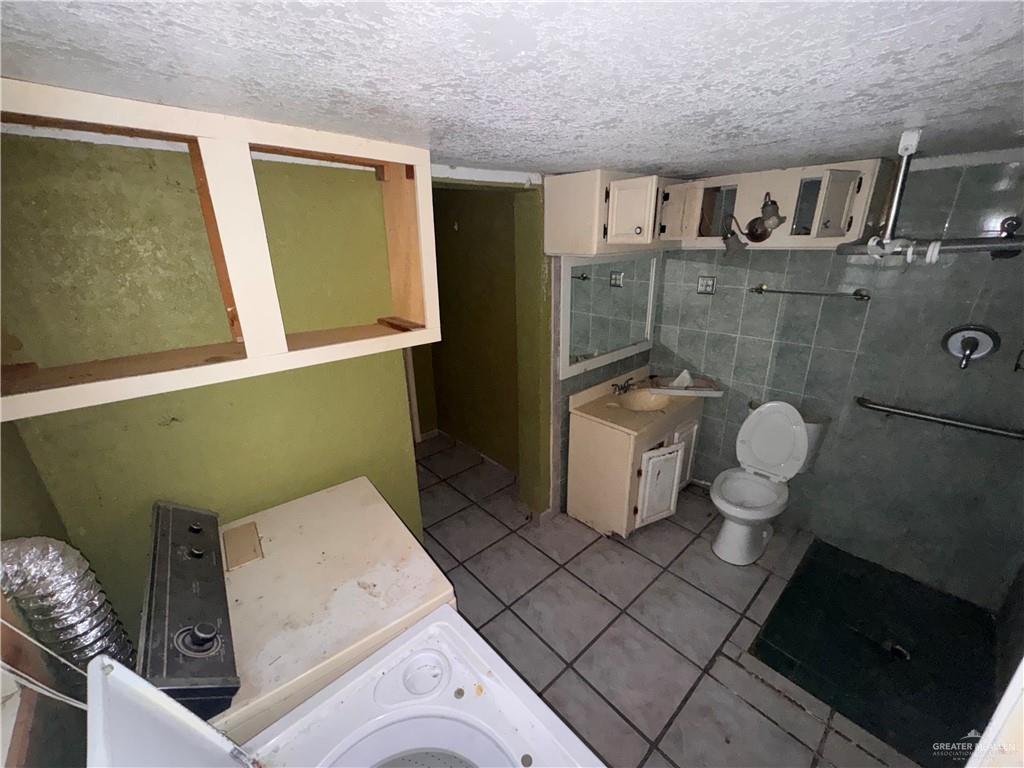 1306 North Rau-Con Street Roma, TX 78584 - Photo 23 of 34 a bathroom with a sink and toilet