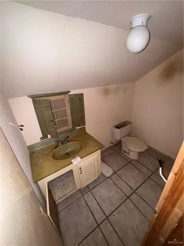 a bathroom with a black white checkered floor