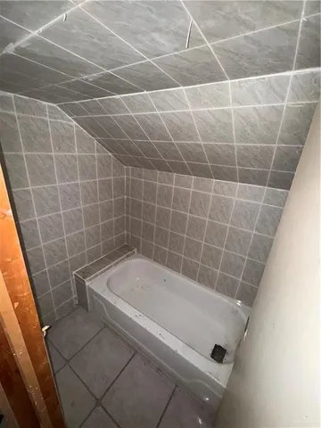 a bathroom with a sink a mirror and a shower