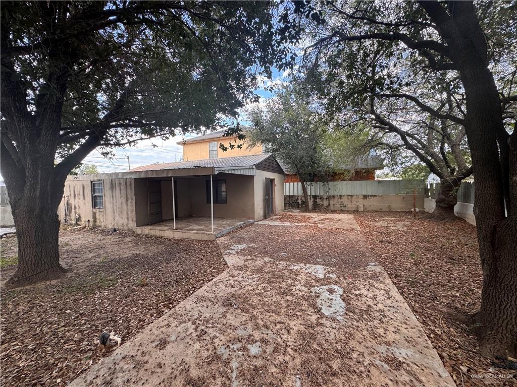 1306 North Rau-Con Street Roma, TX 78584 - Photo 5 of 34 a front view of a house with a garden and trees