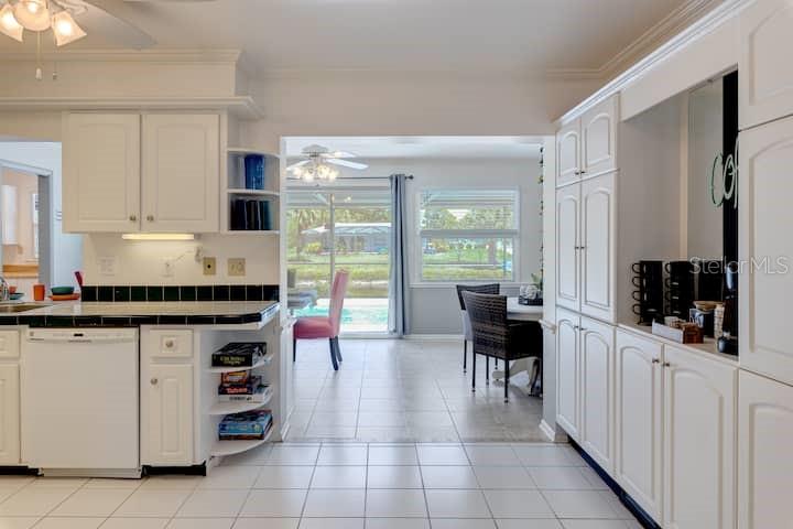 231 Caddy Road Rotonda West, FL 33947 - Photo 11 of 24 a kitchen with stainless steel appliances kitchen island granite countertop a refrigerator and cabinets