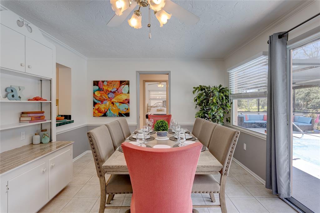 231 Caddy Road Rotonda West, FL 33947 - Photo 13 of 24 a dining room with furniture a large window and potted plants