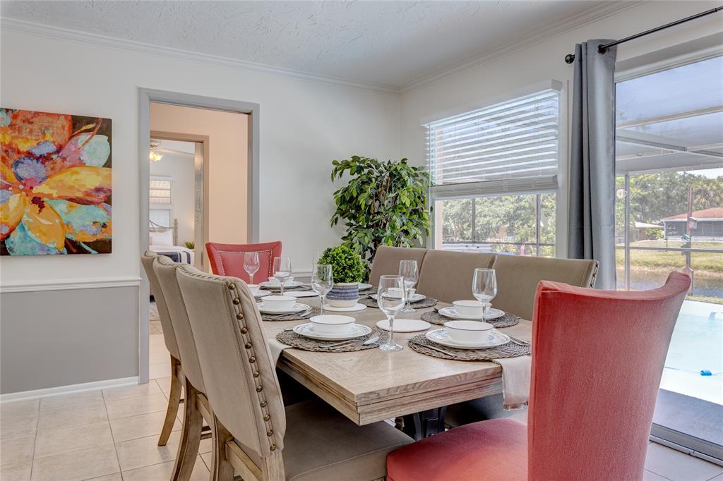 231 Caddy Road Rotonda West, FL 33947 - Photo 14 of 24 a view of a dining room with furniture window and outside view