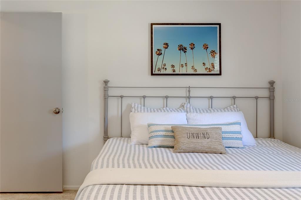 231 Caddy Road Rotonda West, FL 33947 - Photo 18 of 24 a bedroom with a bed and wall painting